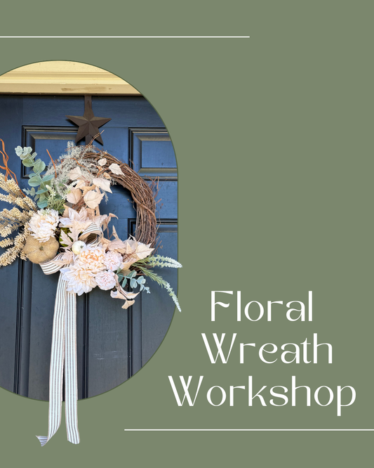 Neutral colored floral wreath on black front door with dried and silk florals and greenery